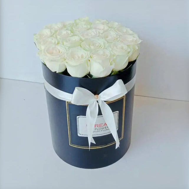 Box of 12 White Roses in a round gift box with a white bow ribbon - Real Flowers Pakistan
