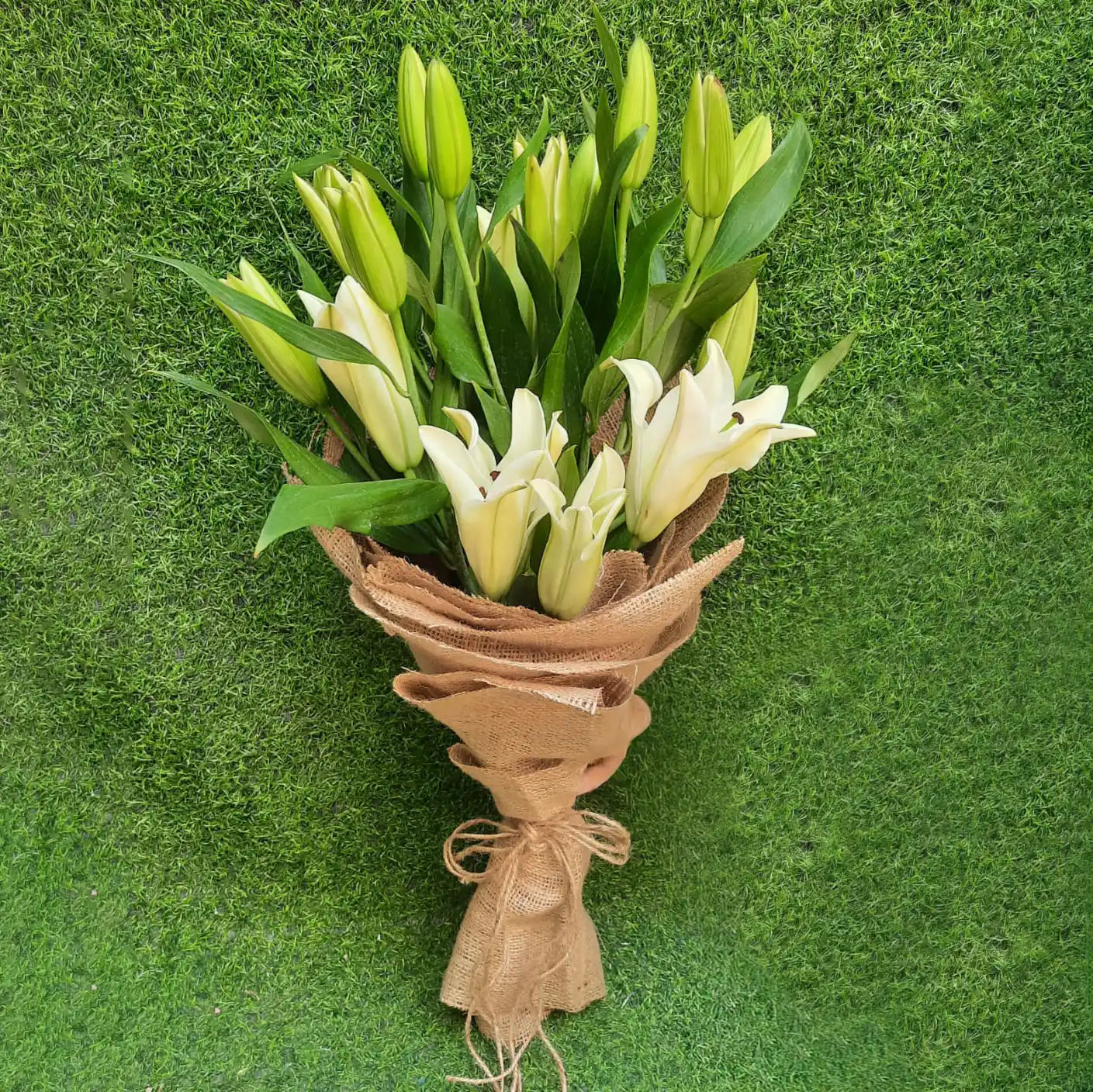 A Hand-Tied Bouquet of fresh Lily flowers wrapped in jute- Real Flowers Pakistan