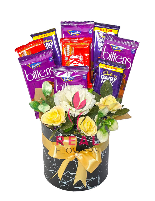 Chocolate and flowers gift box with KitKat, Dairy Milk and Bittens Bars - Real Flowers Pakistan