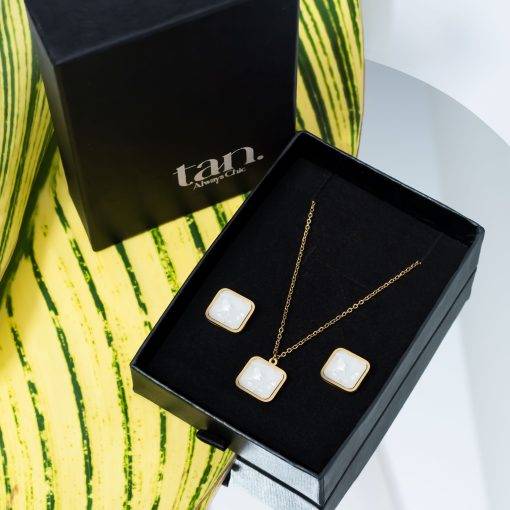 Ivory Luxe necklace set with white shell square pendant and matching gold-tone earrings by tan
