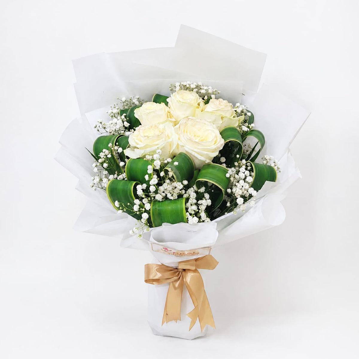 A hand-tied bouquet featuring 5 Imported white roses and Baby’s Breath flowers in a white wrap and ribbon